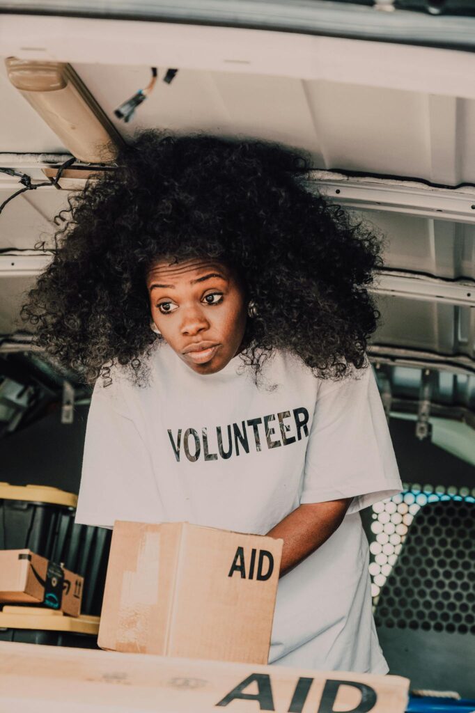 A dedicated volunteer sorting aid boxes, bringing hope and change.
